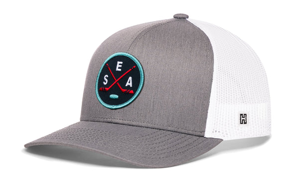 Gray snapback trucker hat with white mesh back and circular SEA X logo patch