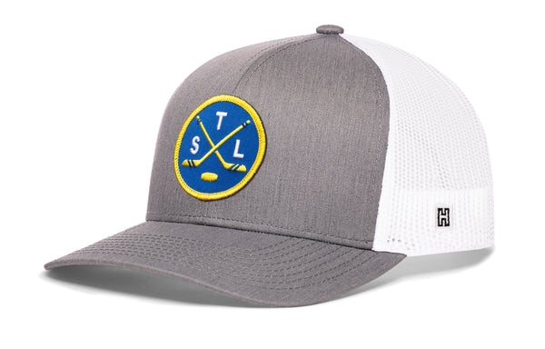 Gray trucker hat with white mesh panels and circular logo patch.