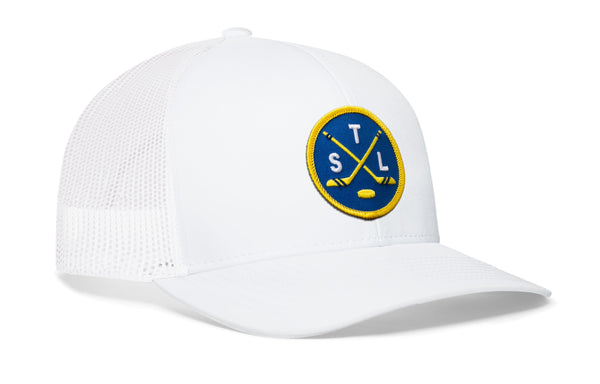 White trucker hat with circular front patch and mesh side panel.
