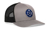 Gray front trucker cap with blue circular logo patch and black mesh side panels