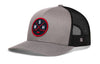 Gray and black trucker cap with red-and-white logo patch and mesh side panels.