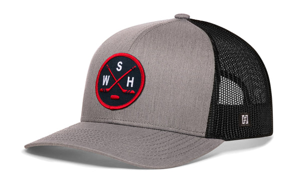 Gray and black trucker cap with red-and-white logo patch and mesh side panels.