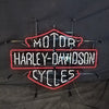 Mounted neon motorcycle sign with red outline, blue MOT0R? and CYCLES, white Harley-Davidson