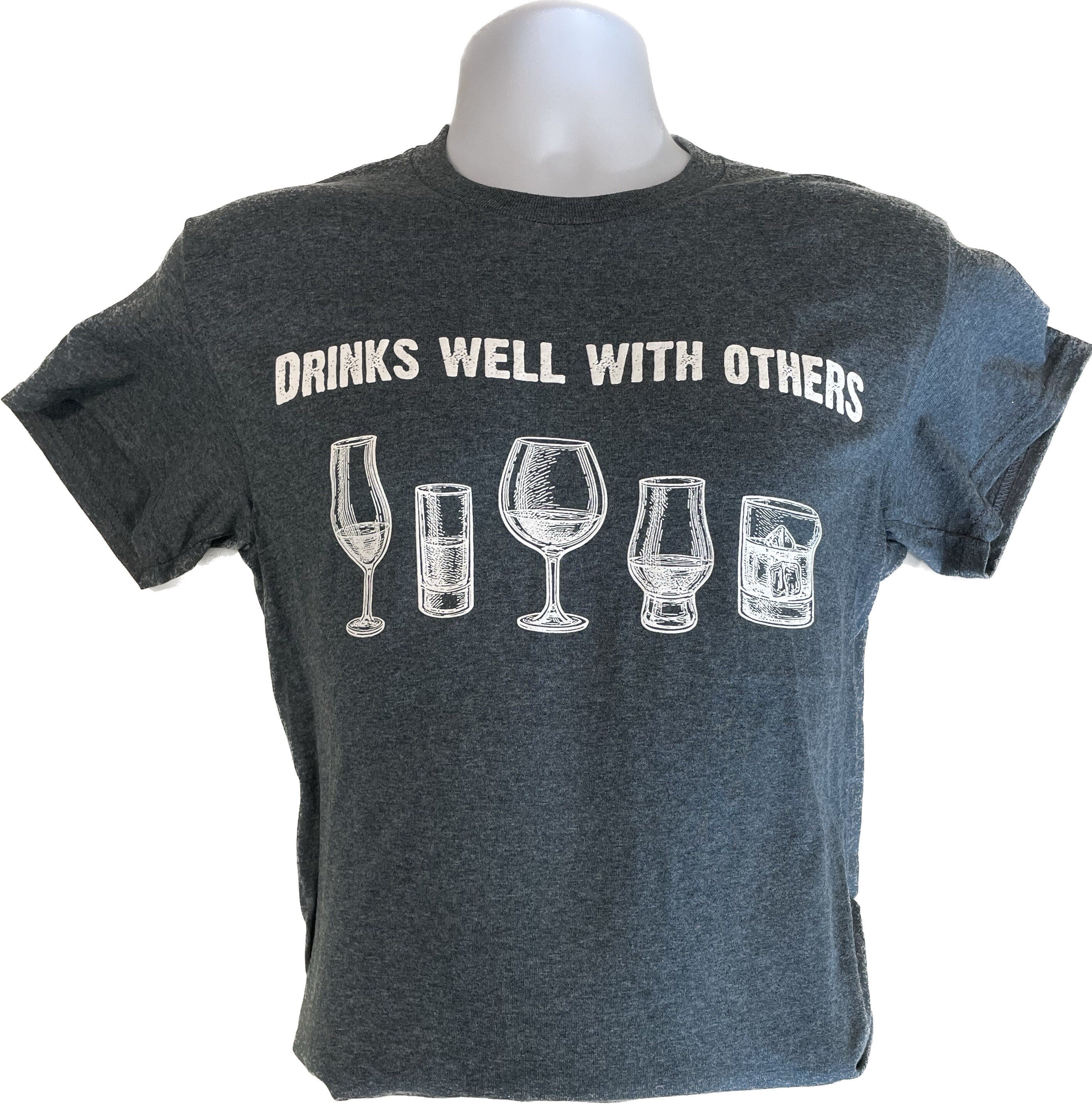 Unisex dark heather T-shirt with drink-glass graphic and 'DRINKS WELL WITH OTHERS'