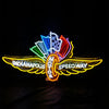 Neon speedway sign light featuring a checkered shield, wheel emblem, and glowing winged text