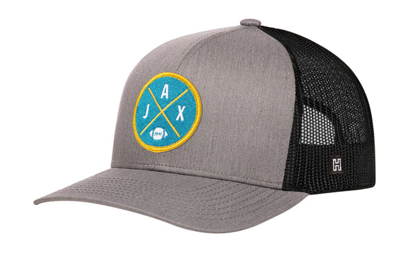 Gray snapback trucker hat with circular team patch and black mesh side panels