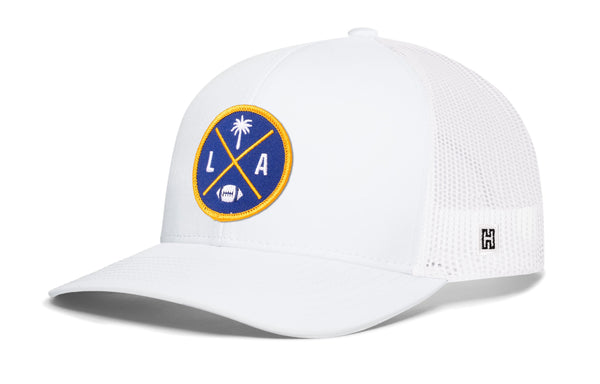 White trucker cap with mesh side panels and round LA X logo patch