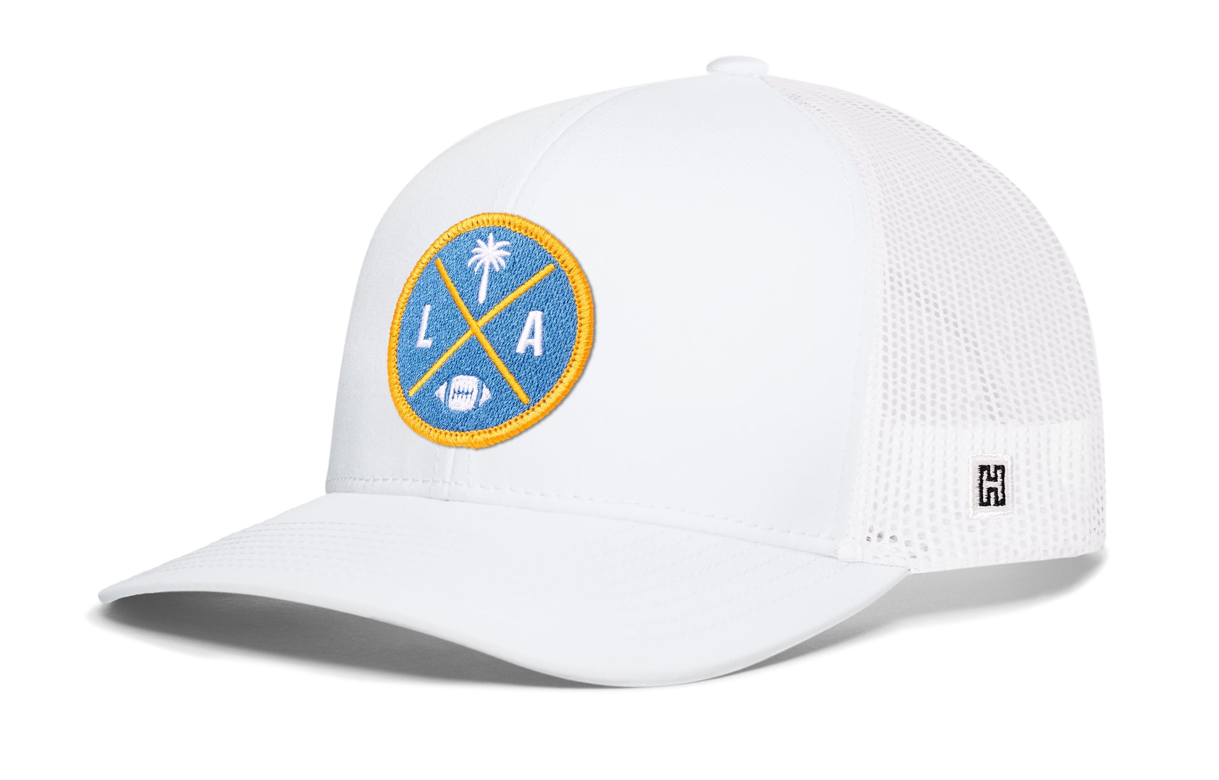White trucker cap with LA X logo patch, white mesh side panels, snapback closure