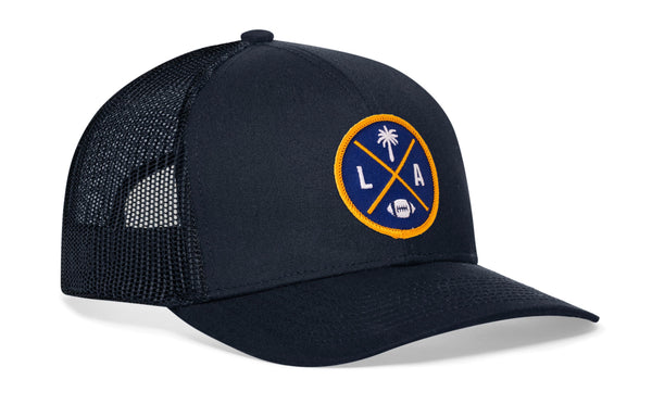 Dark navy trucker cap with black mesh side panels and round LA X logo patch