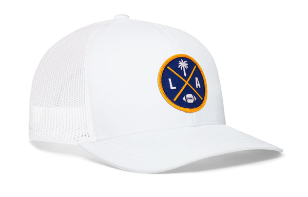 White trucker cap with mesh side panels and round LA X logo patch