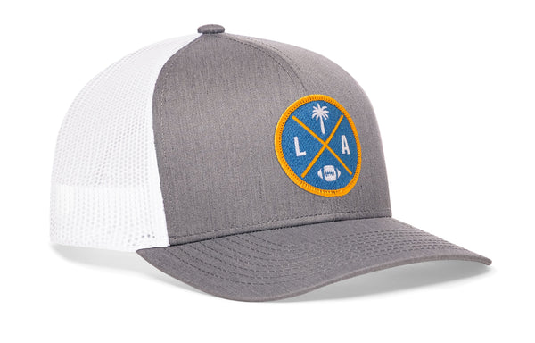 Gray front trucker cap with LA X logo patch, white mesh side panels, snapback