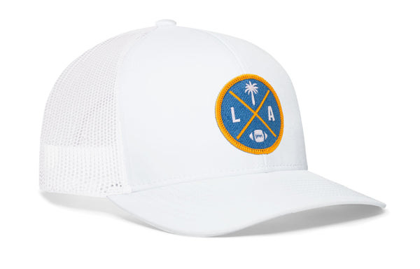 White trucker cap with LA X logo patch and white mesh side panels, snapback