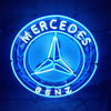 Blue circular neon logo sign with Mercedes three-point star and 'MERCEDES BENZ' text