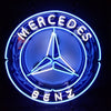 Circular neon logo sign with Mercedes three-point star and 'MERCEDES BENZ' text, blue
