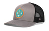Gray trucker cap with black mesh back, curved brim, circular MIA patch on front