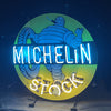 Michelin neon stock light sign, circular green with blue MICHELIN text and yellow STOCK