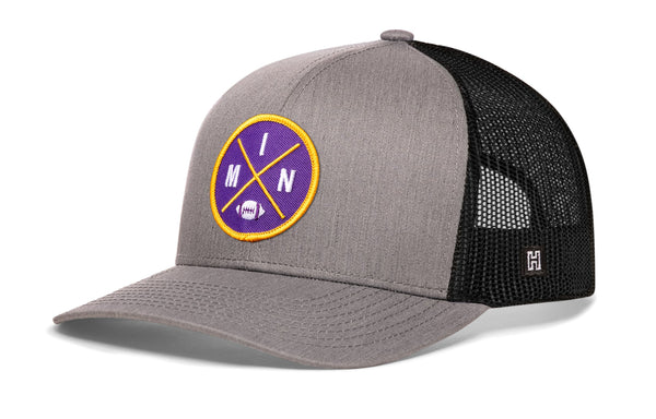 Gray trucker cap with front circular patch and black mesh side panels