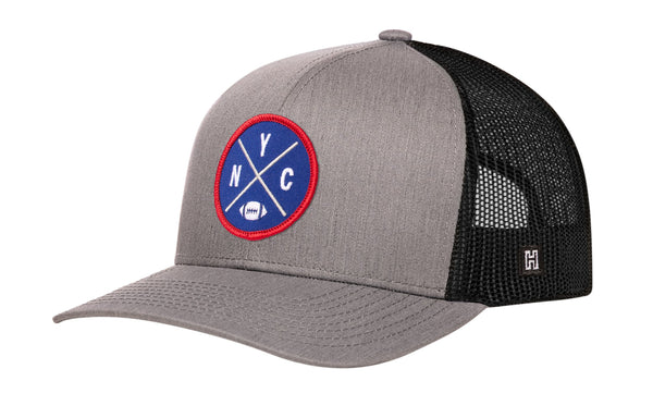 Gray trucker snapback hat with round logo patch and black mesh side panels