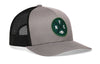Gray-and-black trucker snapback hat with green NYC patch and front logo, mesh back panels