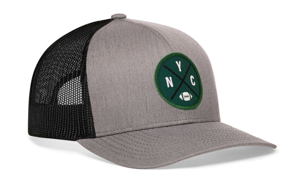 Gray-and-black trucker snapback hat with green NYC patch and front logo, mesh back panels