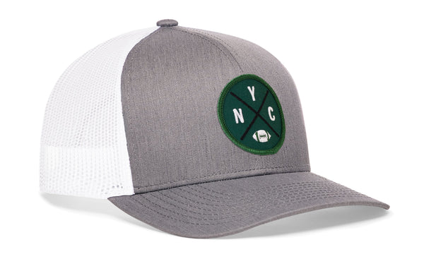 Gray-and-white trucker snapback hat with green NYC patch and front logo, mesh back panels