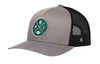 Gray front trucker hat with green round logo patch and black mesh back, snapback