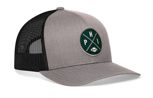 Gray front trucker hat with green round logo patch and black mesh back, snapback