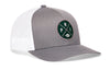 Gray front trucker hat with green round logo patch and white mesh back, snapback