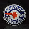 Neon Pontiac service sign with blue ring, red head, and arched wordmark