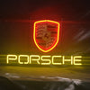 Porsche neon sign with shield emblem and glowing PORSCHE text in yellow and red