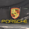 Porsche neon sign with shield emblem and glowing PORSCHE text, mounted on metal frame