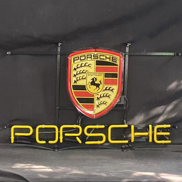 Porsche neon sign with shield emblem and glowing PORSCHE text, mounted on metal frame