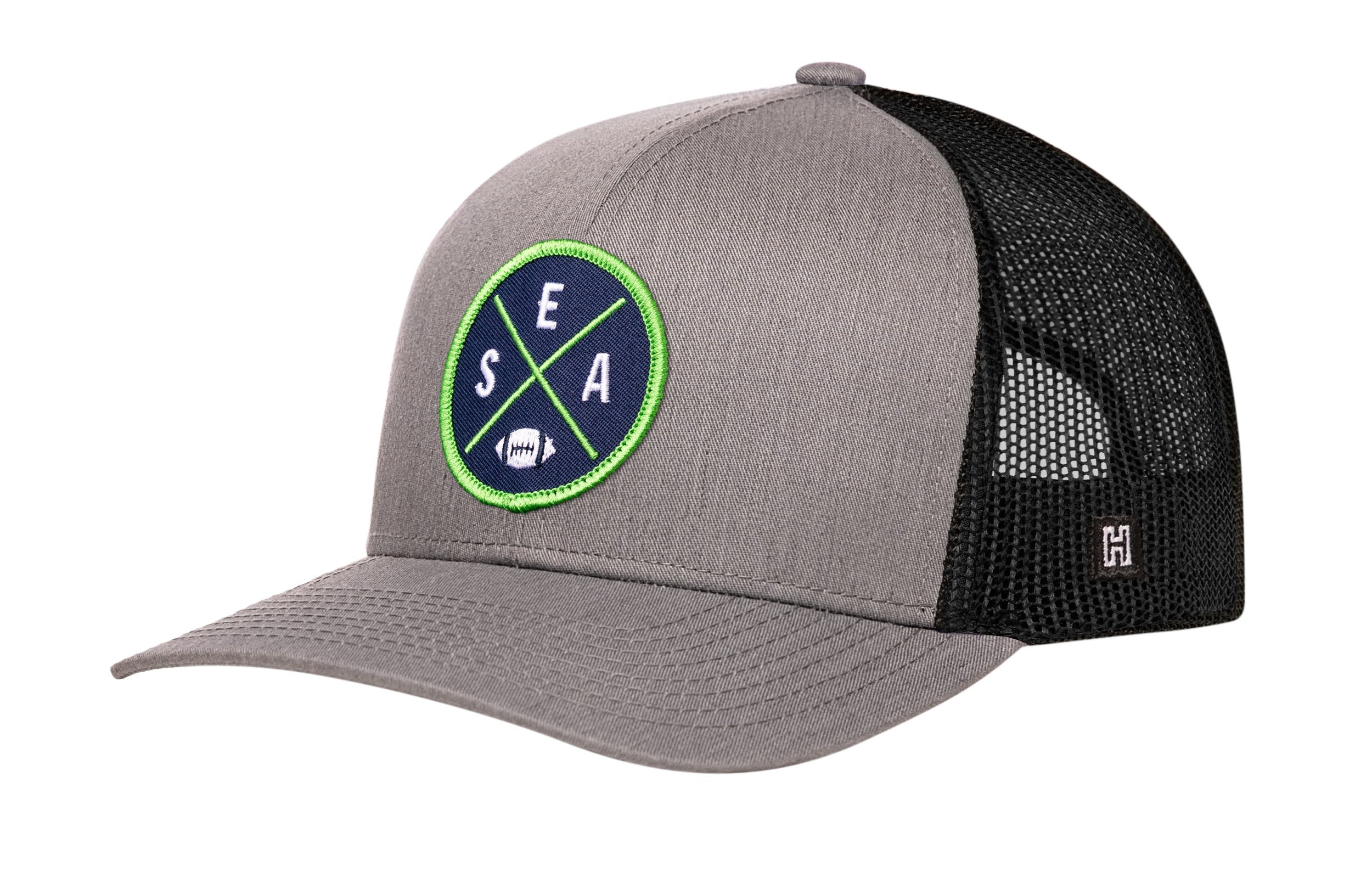 Gray and black trucker baseball cap with green SEA X A logo patch and mesh back
