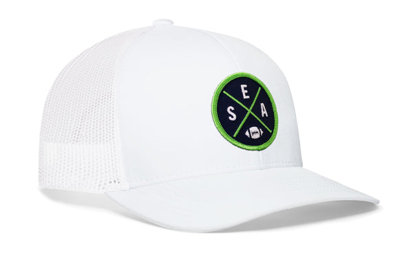 White trucker baseball cap with green SEA X A logo patch and mesh back