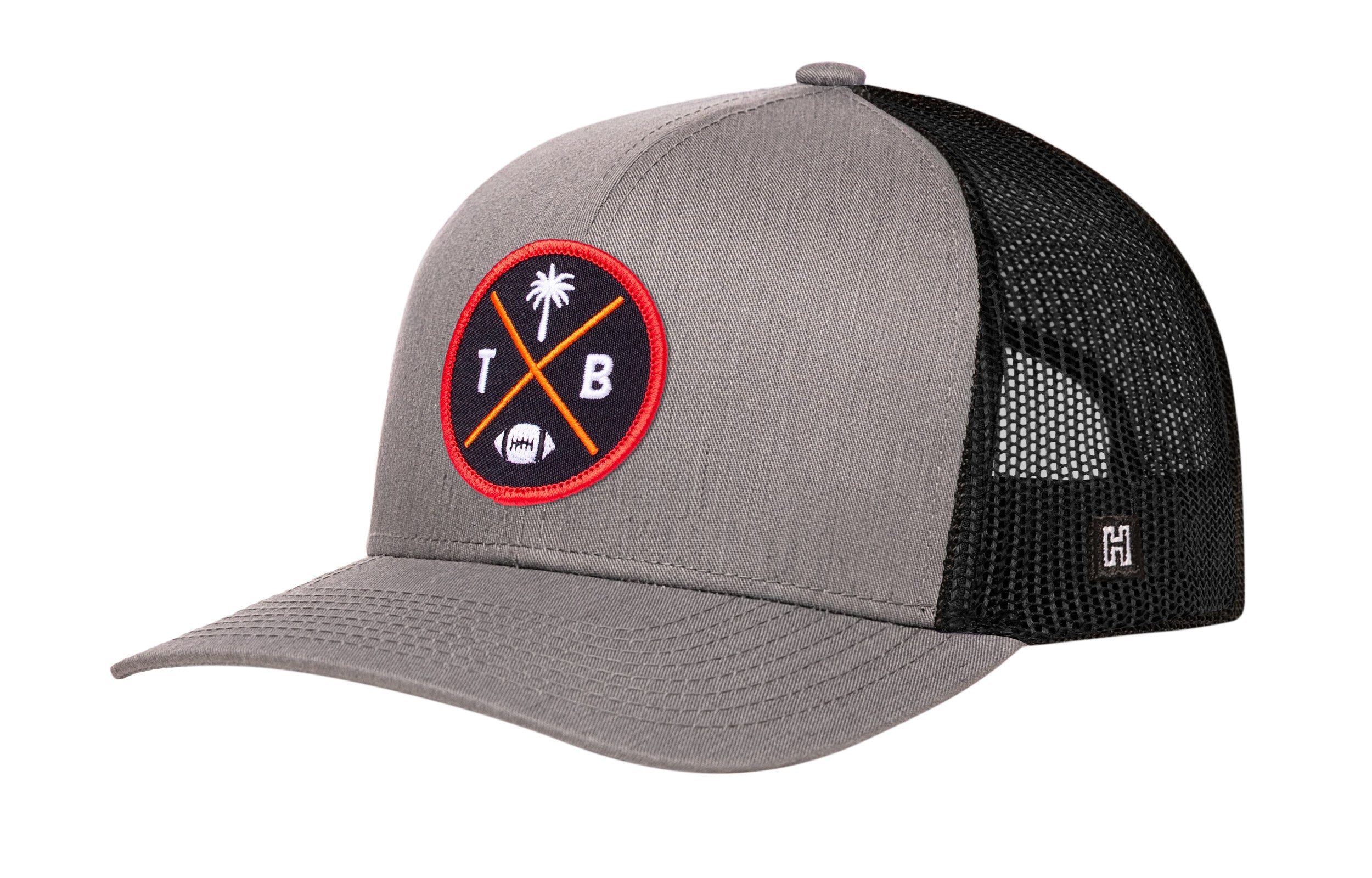 Gray trucker hat with red logo patch, curved brim, and black mesh back panels
