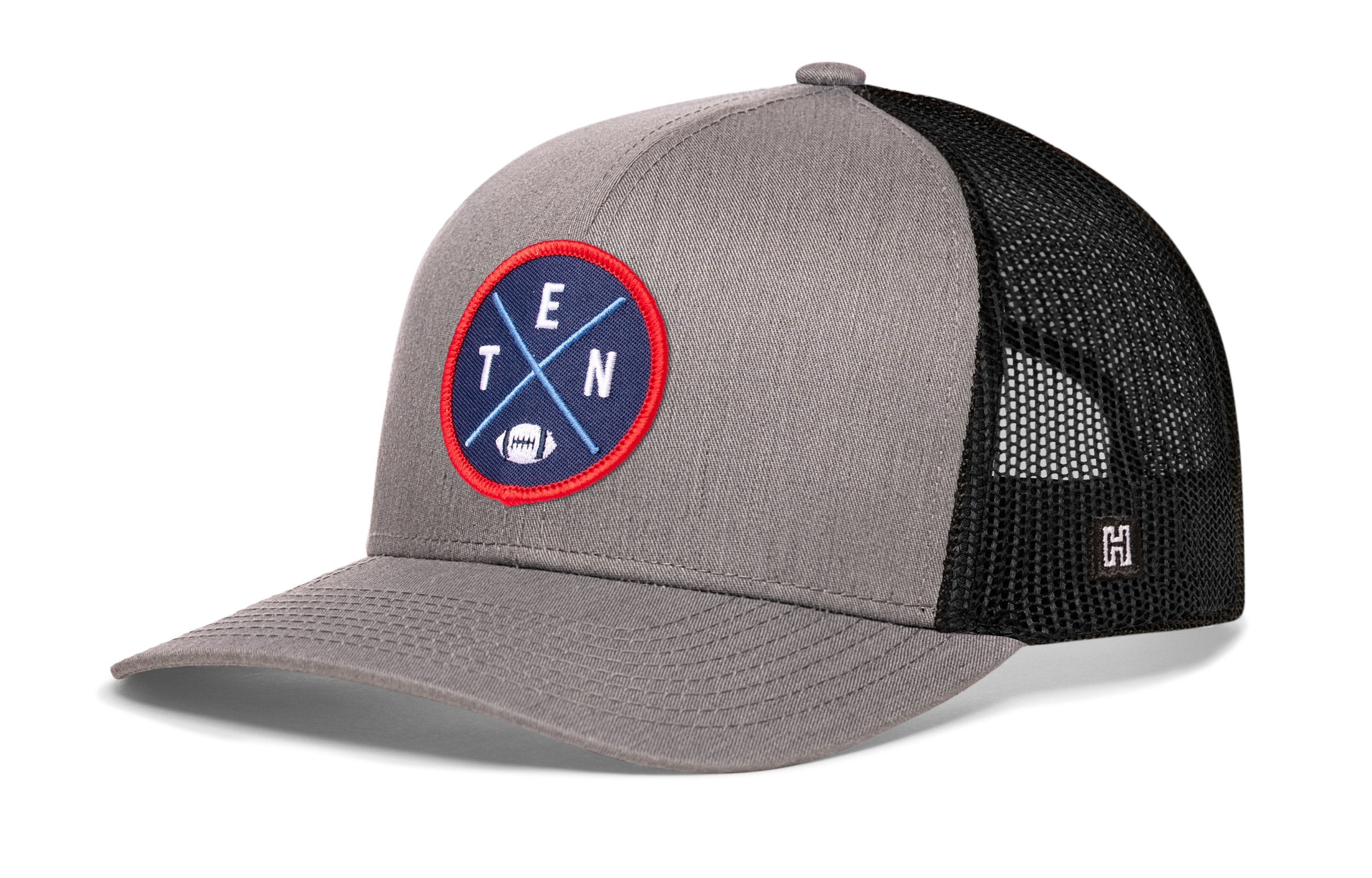 Gray and black trucker cap with mesh side panel, round logo patch, and H emblem