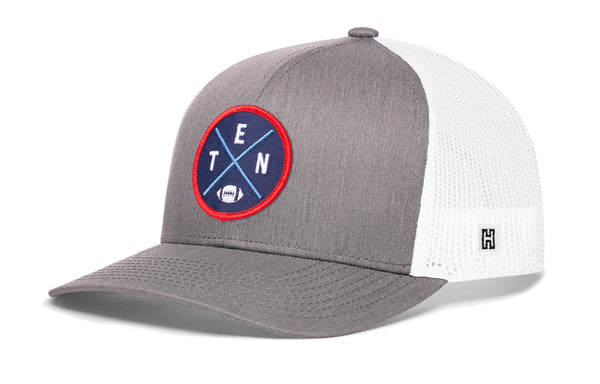 Light gray trucker cap with white mesh side, round logo patch, and H emblem