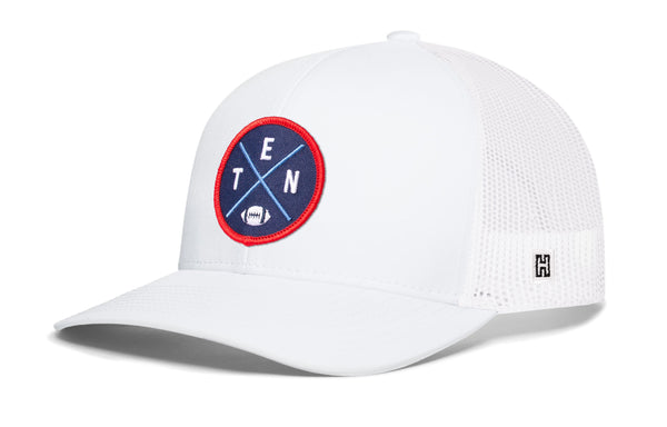 White trucker cap with mesh sides, round logo patch, and small H emblem