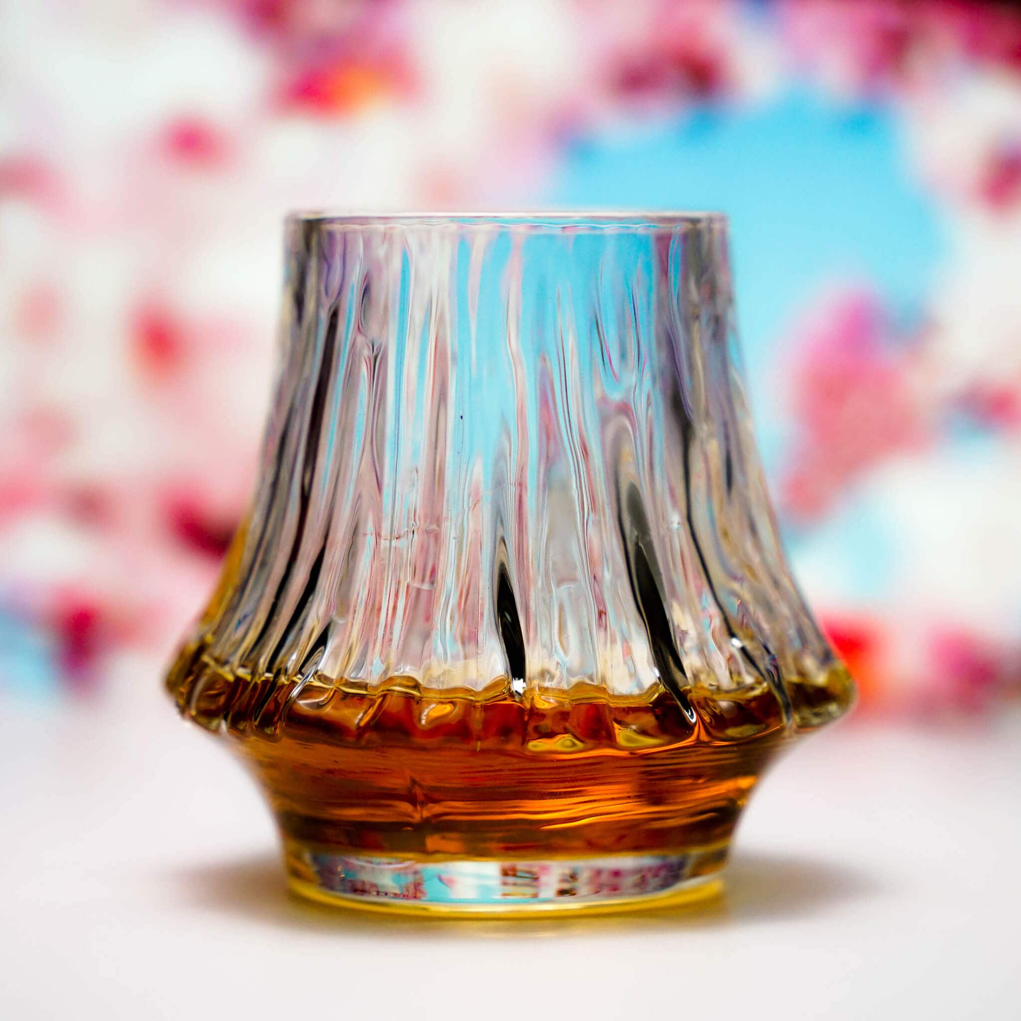 Fluted crystal whisky glass filled with amber whisky