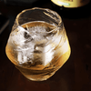 Faceted crystal whisky glass with amber liquid, flared rounded shape