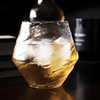 Faceted crystal whisky glass with amber liquid, rounded top rim detail