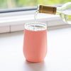 Pink VINGLACE wine tumbler with bottle pouring wine into glass rim