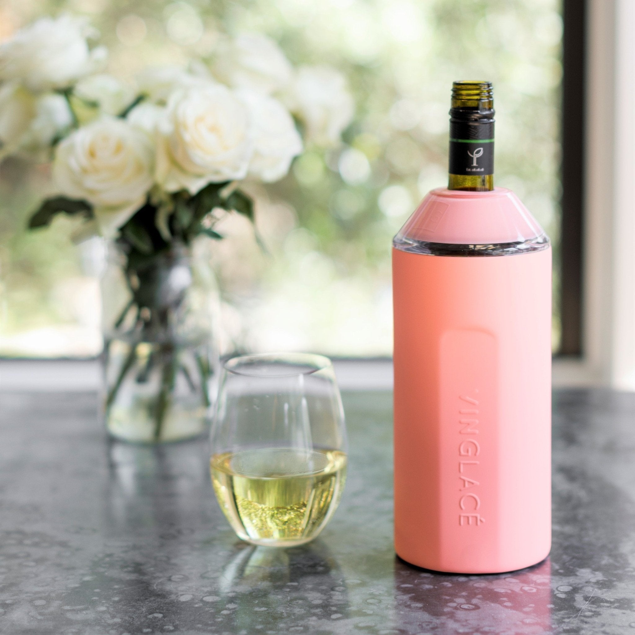 Pink VINGLACE wine cooler with bottle, wine glass, and floral centerpiece