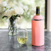 Pink VINGLACE wine cooler with bottle, wine glass, and floral centerpiece