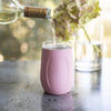 Pink VINGLACE tumbler cup with bottle pouring wine into top