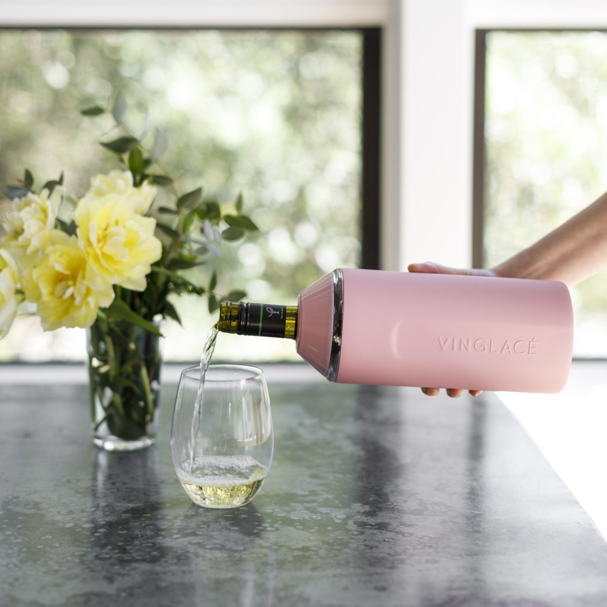 Pink VINGLACE insulated wine cooler with stem glass and bottle pouring in